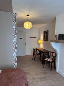 a living room with a dining room table and a dining room at Le Verger in La Charmée