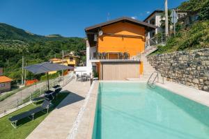 a villa with a swimming pool and a house at Casa Santari in Parzanica