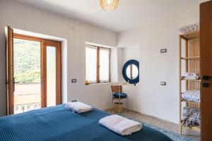 a bedroom with a blue bed and a window at Casa Santari in Parzanica +49 photos