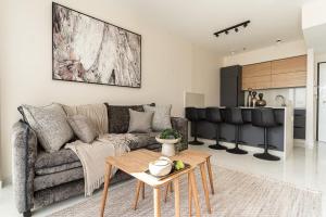 a living room with a couch and a table at Savyon View Tower - Isrentals in Jerusalem
