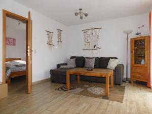 a living room with a couch and a table at Hus an de Küst 02 in Ahrenshoop