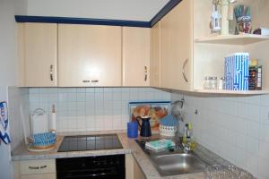 a kitchen with a sink and a counter top at Boddenhus in Born
