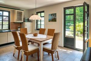 a kitchen with a wooden table and chairs at Strandhaus Ahrensh 1 in Ahrenshoop