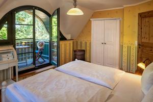 a bedroom with a bed and a large window at Strandhaus Ahrensh 1 in Ahrenshoop