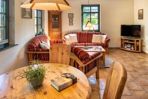 a living room with couches and a wooden table at Strandhaus Ahrensh 2 in Ahrenshoop