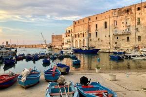 a group of boats are docked in a harbor at Sunny Vibes Monopoli in Monopoli
