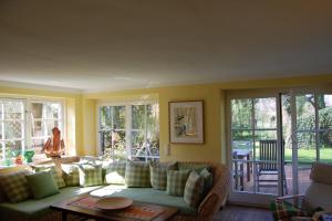 a living room with a couch and some windows at Sonnendeck in Born