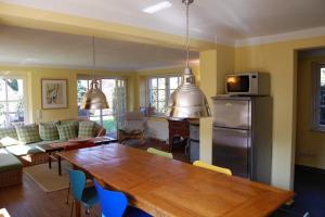 a living room with a wooden table and a kitchen at Sonnendeck in Born +6 photos