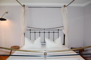 a bedroom with a bed with white pillows at Sonnendeck in Born