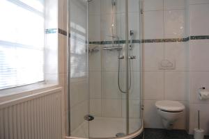 a bathroom with a shower and a toilet at Sonnendeck in Born
