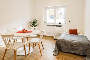 a bedroom with a bed and a table and chairs at Umberto I by Casa di Marco in Sannicola