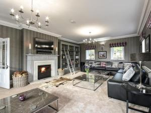 a living room with a couch and a fireplace at 6 Bed in Otley oc-g0022 in Fewston