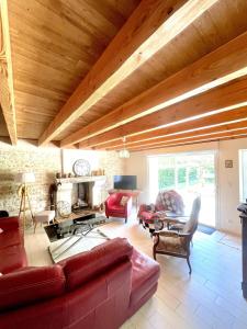 a living room with a couch and a fireplace at La maison de La Combe in Parzac