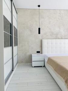 a bedroom with a bed and a large window at Золотий Бугаз корп5 апарт3 in Odesa