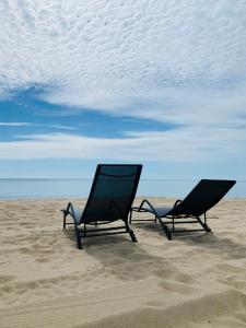 two chairs sitting in the sand on the beach at Золотий Бугаз корп5 апарт3 in Odesa