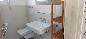 a bathroom with a sink and a toilet at Schäfer Apartments in Oberderdingen +2 photos