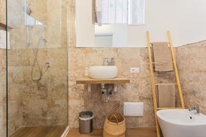 a bathroom with a sink and a shower at Sunny Vibes Monopoli in Monopoli +33 photos