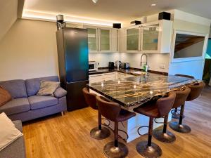 a kitchen with a table and a couch in a room at Malergarten 05 in Ahrenshoop +7 photos