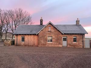 an old brick house sitting on top of a field at Hoolet's View, East Lothian in Whittingehame