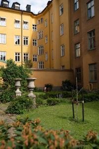 a large building with a garden in front of it at Executive Living Södermalm Chic in Stockholm