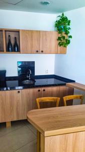 a kitchen with wooden cabinets and a wooden table at VISTA ESPETACULAR - TWIN TOWERS - Barra da Tijuca in Rio de Janeiro +21 photos