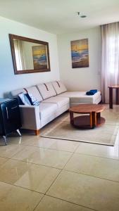 a living room with a couch and a coffee table at VISTA ESPETACULAR - TWIN TOWERS - Barra da Tijuca in Rio de Janeiro