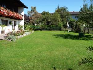 a yard with a gazebo and green grass at Ferienwohnungen Wennesz in Chieming +4 photos