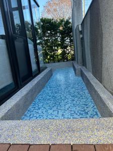 a walkway with blue tiles on the side of a building at Find 777 B&B in Guilin