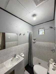 a bathroom with a sink and a toilet at Zara's Casa Rental in Siquijor