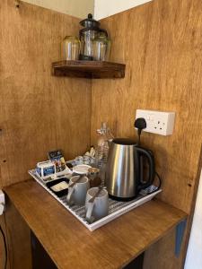 a kitchen counter with a tea pot on a tray at Tanglin Guest House in Oban