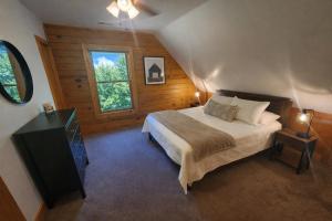 a bedroom with a bed and a window at Wilderness retreat in Marion