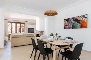 a living room with a dining room table and chairs at YourHouse Casa Rafael in Can Picafort
