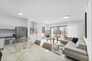 a kitchen and living room with a couch and a table at Savyon View Tower - Isrentals in Jerusalem