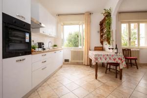a kitchen with a table and a dining room at Casa Curti 1 in Sorico