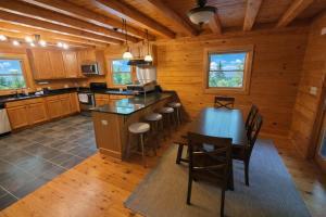 a kitchen with a table and chairs in a cabin at Wilderness retreat in Marion