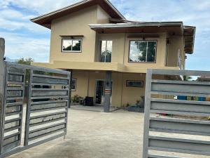 a house with a gate in front of it at Scarlett Near Mount Zion in Bugallon