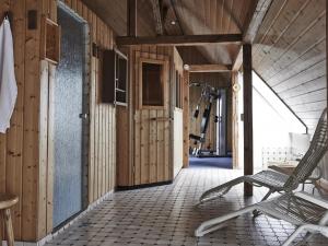 a gym with a chair in a room with wooden walls at DORMERO Hotel Crailsheim in Crailsheim