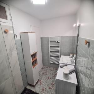 a white bathroom with a sink and a toilet at Joli Eden in Saint-Sulpice-de-Faleyrens +16 photos