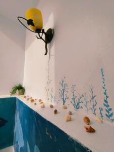 a wall with a painting of a fish and shells at Yabiya home stay in Lanyu +1 photo