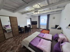 a hotel room with two beds and a mirror at Harmony Vendégház Egerszalók in Egerszalók