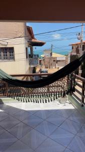 a hammock on top of a patio with a building at Casa Maré in Aracati