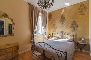 a bedroom with a bed and a chandelier at Lovran deluxe apartman in Lovran