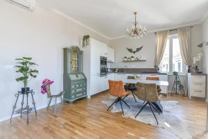a kitchen with a table and chairs in a room at Lovran deluxe apartman in Lovran