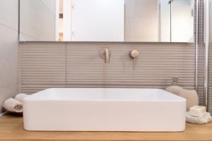 a bathroom with a large white tub in a room at Savyon View Tower - Isrentals in Jerusalem +169 photos