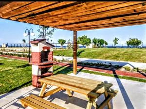 a wooden bench on a patio with a brick oven at Villa PALA in Kemer