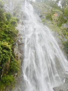 a waterfall on the side of a mountain at Bambarakanda eco resort in Welegama