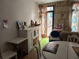 a living room with a table and a chair at Alfonso XII in Redondela