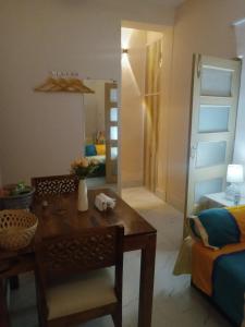 a living room with a table and a mirror at Beautiful 1-bed Apartment-Suite Kolkata near Airport in Kolkata