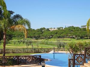 a pool with a view of a golf course at Formosa Villas in Quinta do Lago