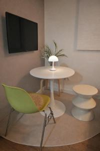 a table and chairs in a room with a tv at The YoGwan in Suwon